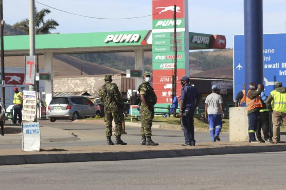 Eswatini soldiers and police officers are seen on the streets near the Oshoek Border Post between Eswatini and South Africa on July 1, 2021.