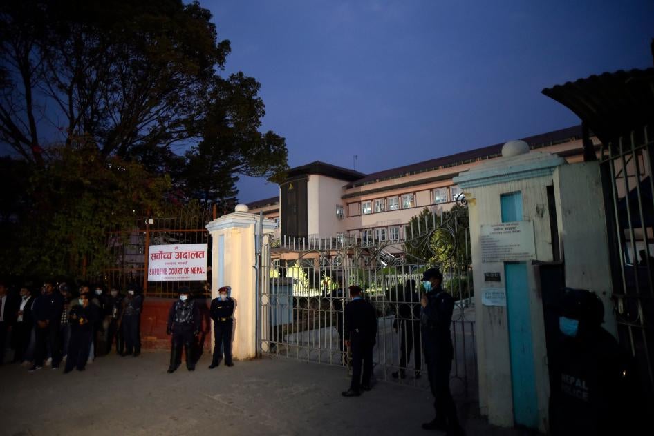 Police stand outside the Supreme Court of Nepal on February 23, 2021, following its ruling to reinstate the dissolved House of Representatives.