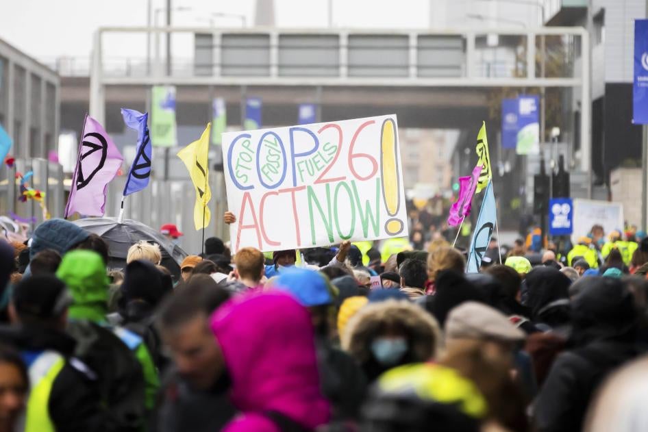 12 November 2021, United Kingdom, Glasgow: A poster calling for better climate protection is held aloft during a protest outside the grounds of the UN Climate Change Conference COP26. Photo by: Christoph Soeder/picture-alliance/dpa/AP Images