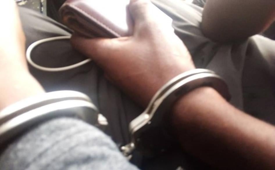 A close-up photo of hands in handcuffs