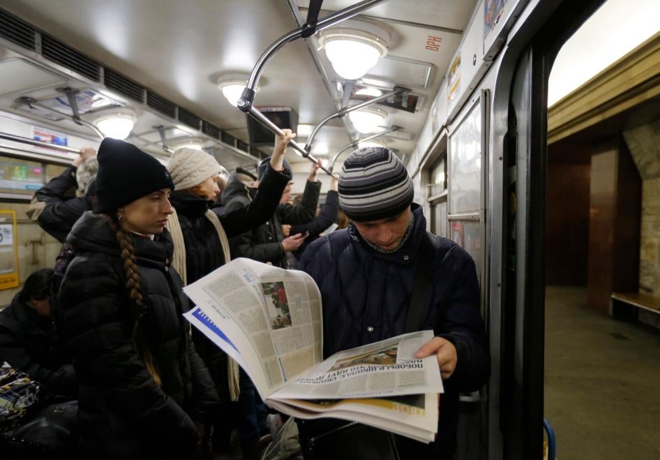 A man reads a newspaper at a metro station, in Kiev, Ukraine, February 12, 2015.