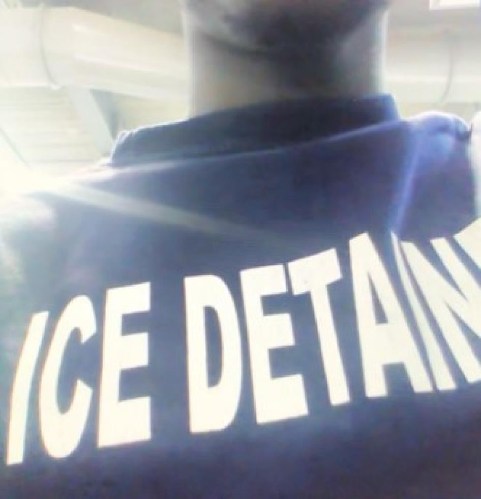 A man wearing a shirt that reads "ICE DETAINEE"