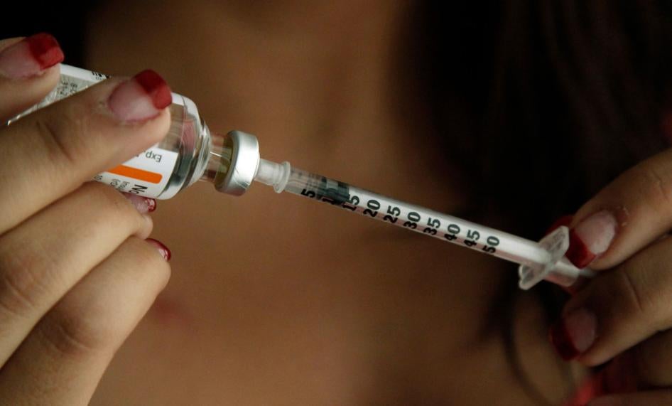 A woman fills a syringe with insulin at her home in the Los Angeles suburb of Commerce, California, April 29, 2019.