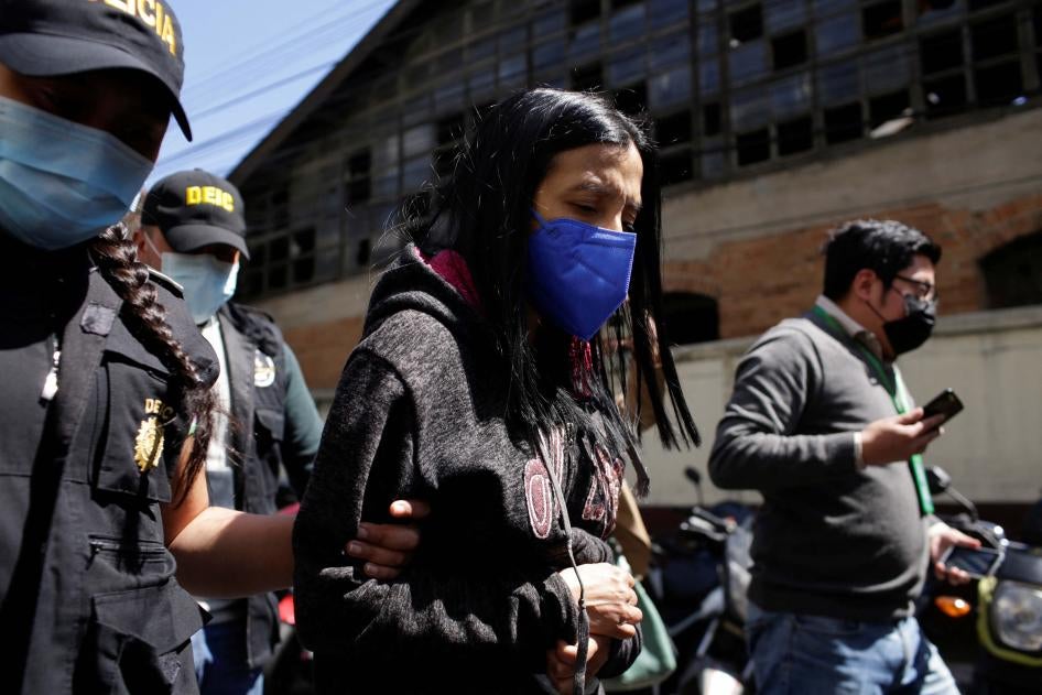 Anti-corruption prosecutor Leily Santizo is escorted by police officers to the Supreme Court of Justice in Guatemala City, Guatemala, on February 10, 2022.