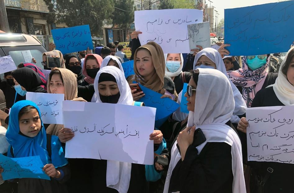 Women chant and hold signs at a protest