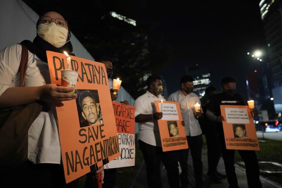 Activists holds posters against the impending execution of Nagaenthran K. Dharmalingam