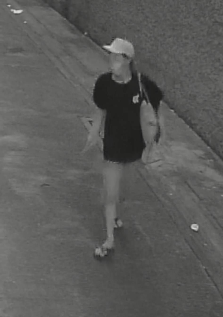 Photo captured on a security camera of the alleged assailant, a woman wearing a mask and a black t-shirt.