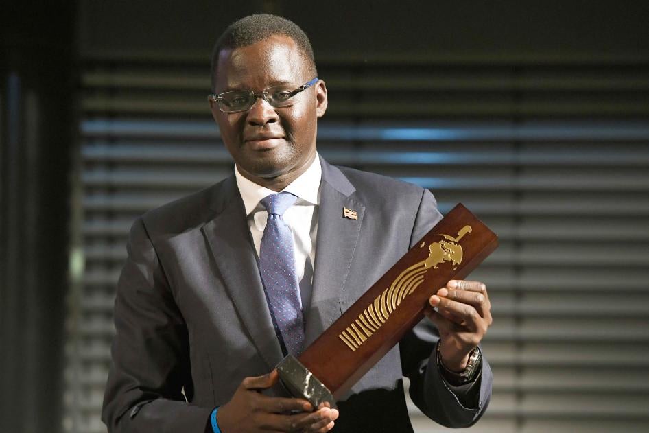 Nicholas Opiyo, human rights lawyer and founder of Chapter Four Uganda, holds the German Africa Award