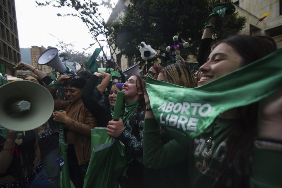 Activists holding green bandanas 