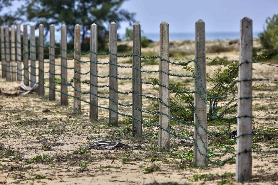 Razor wire fencing on a beach