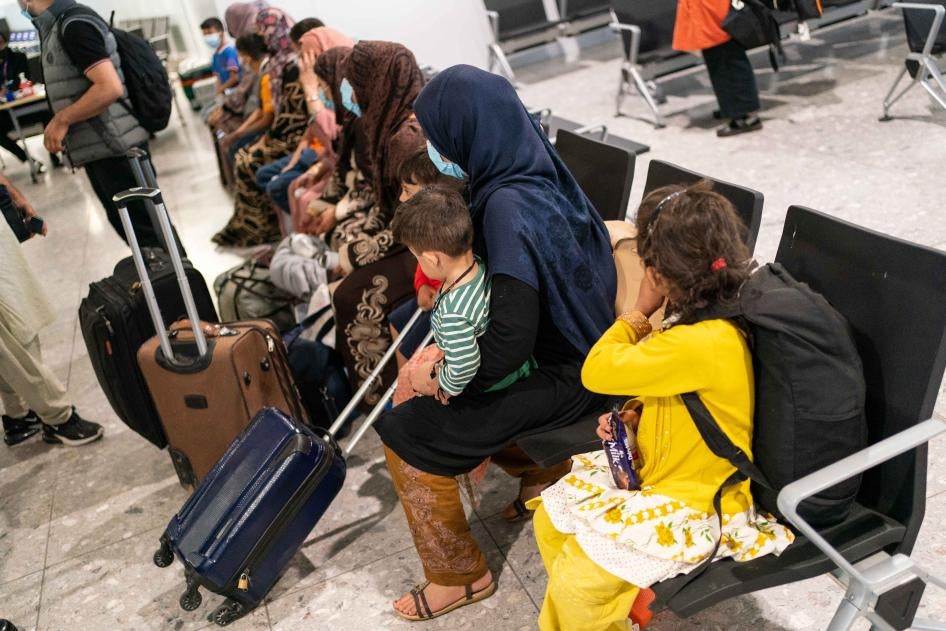 Refugees from Afghanistan wait to be processed after arriving on an evacuation flight at Heathrow Airport, London, on August 26, 2021.