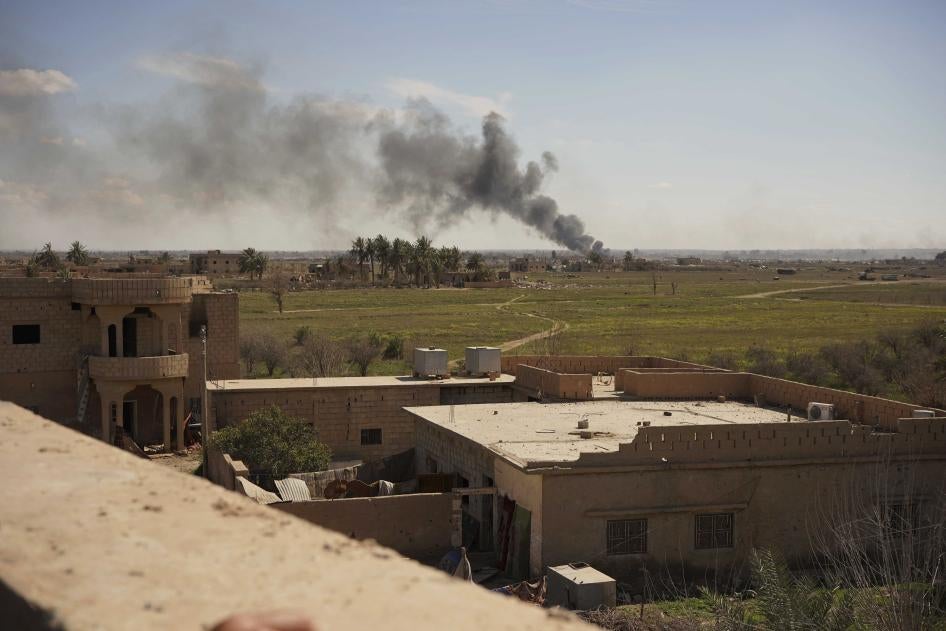 Black smoke billows from the last small piece of territory held by Islamic State forces as US-backed fighters attack the area with artillery and airstrikes in Baghouz, Syria, March 3, 2019. © 2019 AP Photo/Andrea Rosa