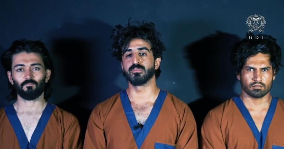 Ajmal Haqiqi (center) and two colleagues after their arrest
