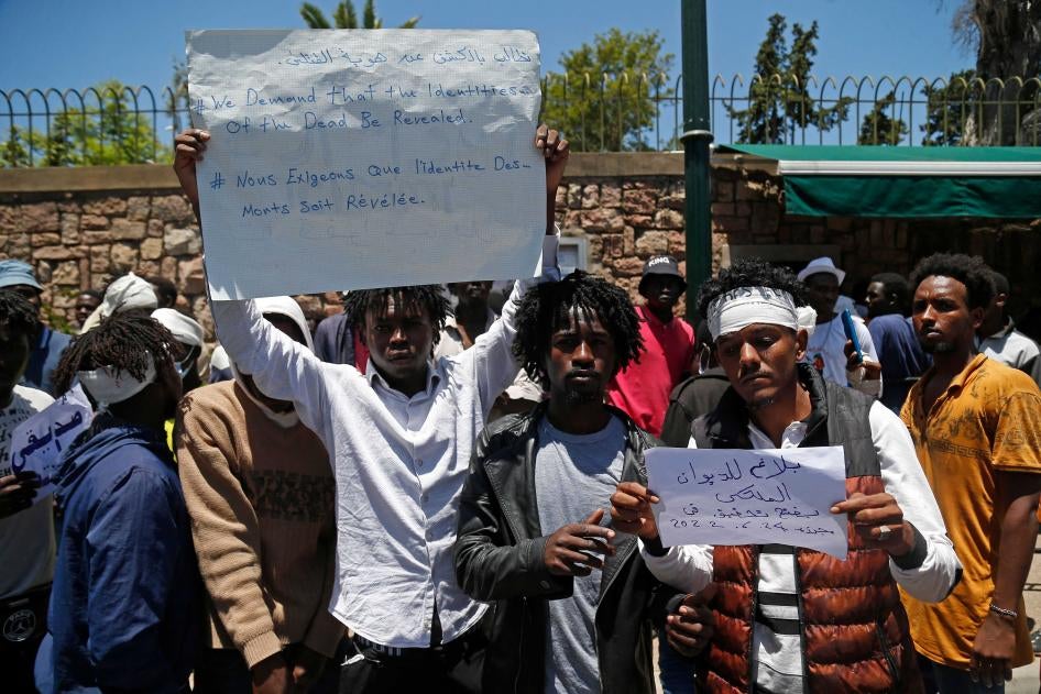 Migrants hold placards during an anti-racism demonstration