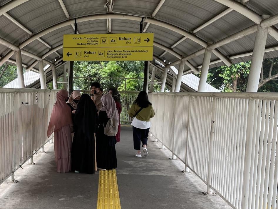 Beberapa siswi sekolah menengah berjalan di sebuah stasiun kereta api Jakarta, ikut kegiatan ekstrakurikuler, pakai jilbab dan baju panjang, Juni 2022.