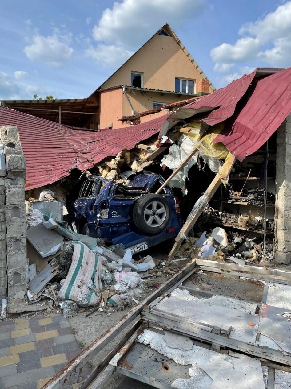 Damage caused to a garage and civilian car during an attack on a Russian tank in Malaya Rohan, around March 17, May 24, 2022.