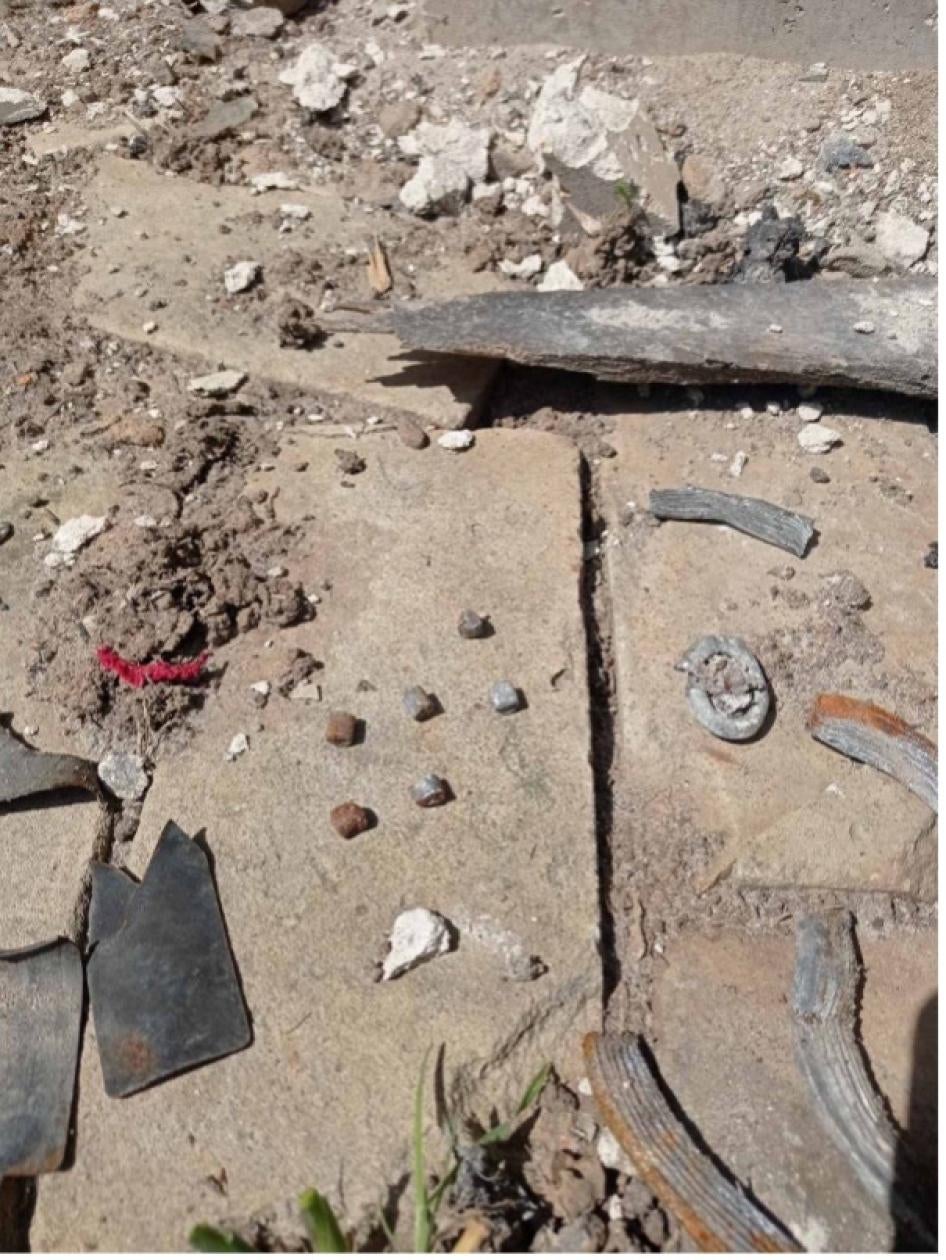 The gathered remnants of at least one rocket-delivered explosive submunition, which landed in the garden of Svitlana and Serhii Lukianenko in Derhachi on May 12, 2022, killing them, May 12, 2022. 