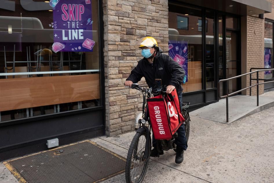 A delivery man bikes with a food bag from Grubhub in New York, April 21, 2021