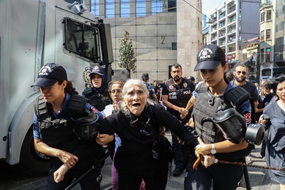 Photo shows police arresting Emine Ocak, mother of Hasan Ocak abducted and murdered in 1995