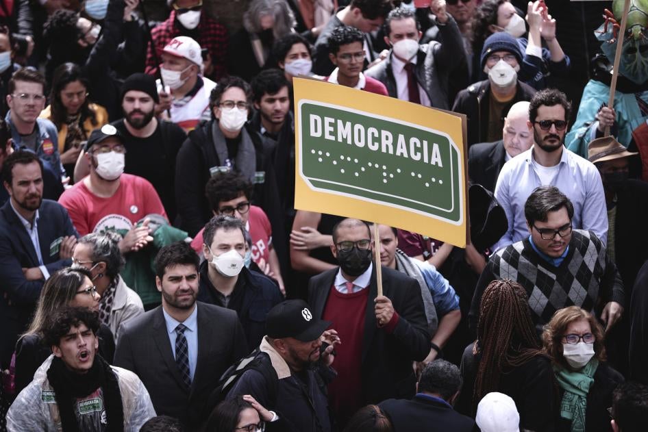 A protester holds a sign reading “Democracy” in Portuguese and in Braille at a rally in in São Paulo, August 11, 2022.