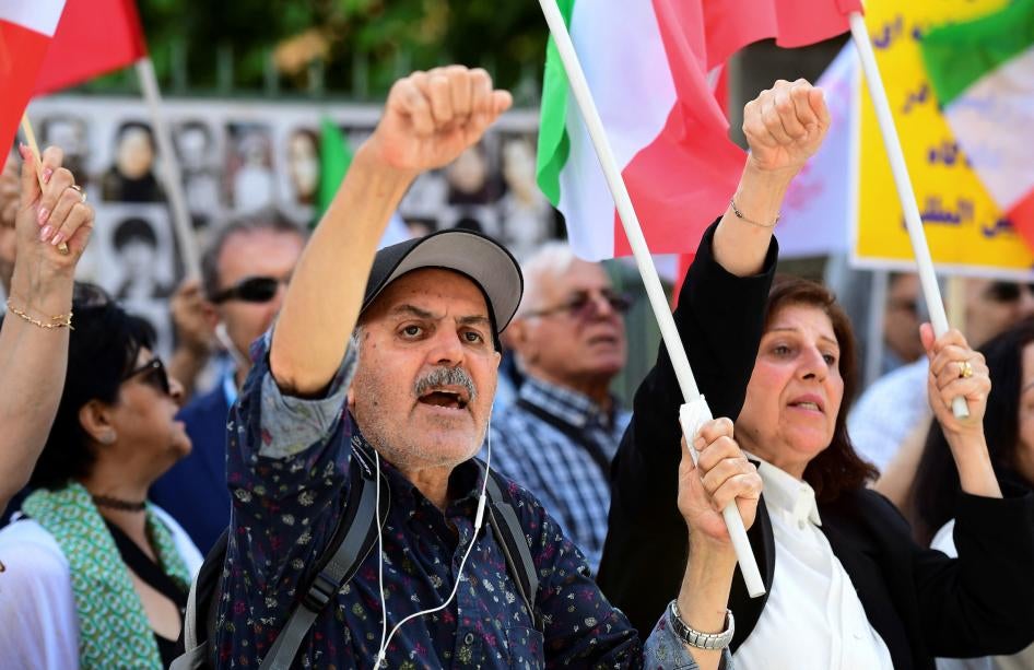 People react to the verdict of Hamid Noury, a former Iranian official sentenced to life in prison, outside the Stockholm District Court, Sweden on July 14, 2022.