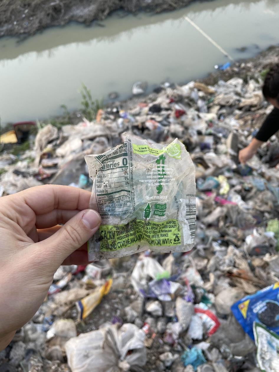 A person holds up a piece of plastic waste