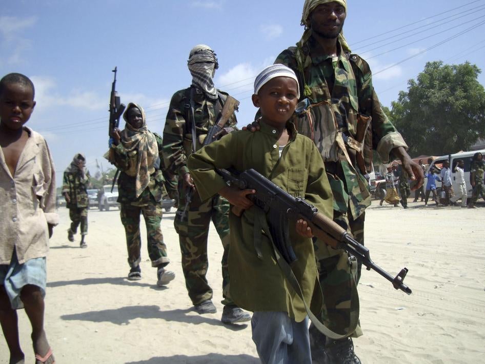 A young boy leads hard-line Islamist al-Shabab fighters in Mogadishu, Somalia. 