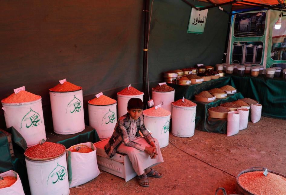 A Yemeni boy sits in a dry goods shop in a traditional market in Sanaa, Yemen.