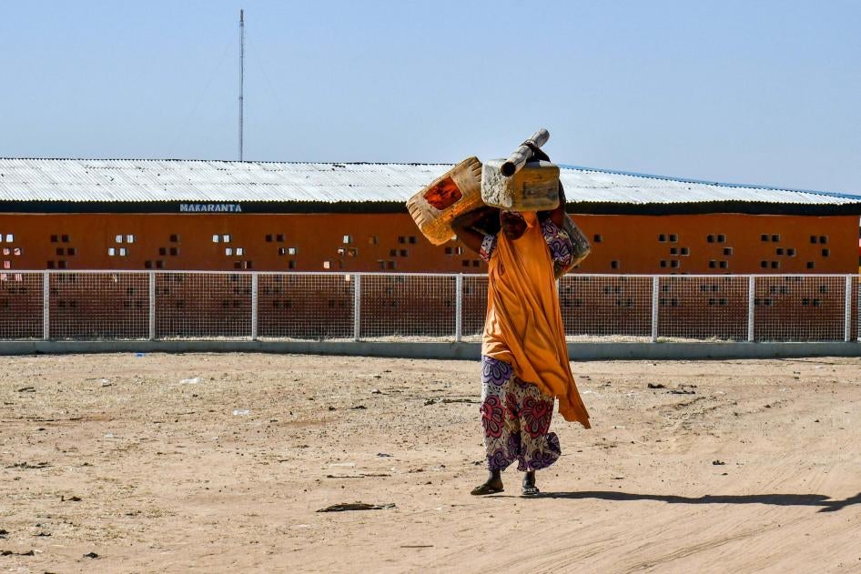 Une femme qui vivait dans le camp de Bakassi pour personnes déplacées à Maiduguri dans l'État de Borno, au Nigeria, transportait ses affaires et se dirigeait vers la sortie le 30 novembre 2021. La fermeture de ce camp, parmi d’autres, avait précédemment été annoncée par le gouvernement de cet État.