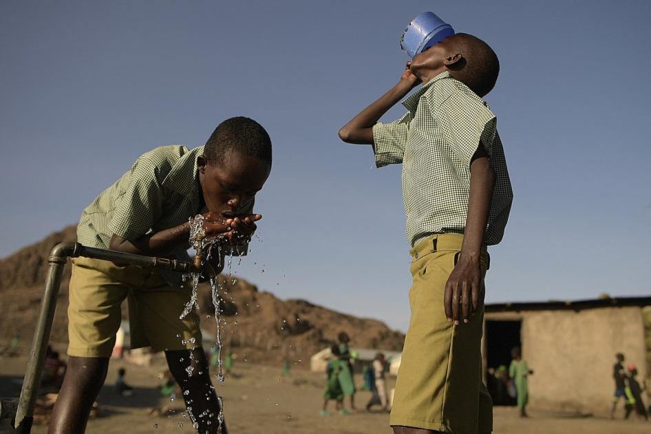 Pupils of El-molo bay primary school drink from a tap, in Loiyangalani, northern Kenya.