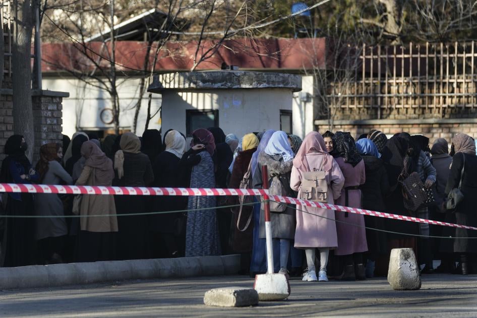 Afghan female students line up at one of Kabul University's gates