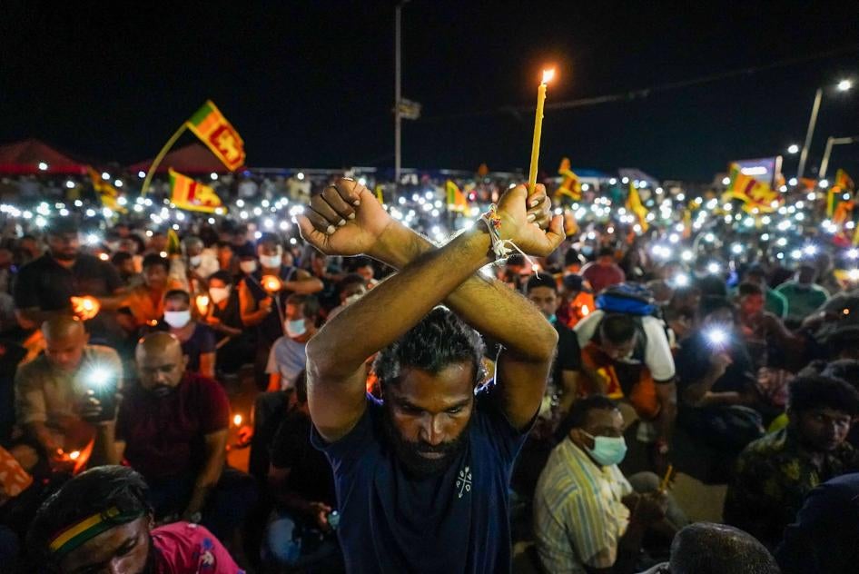 Demonstrators light candles and flash mobile phone lights during a silent protest near the president's office in Colombo, Sri Lanka.