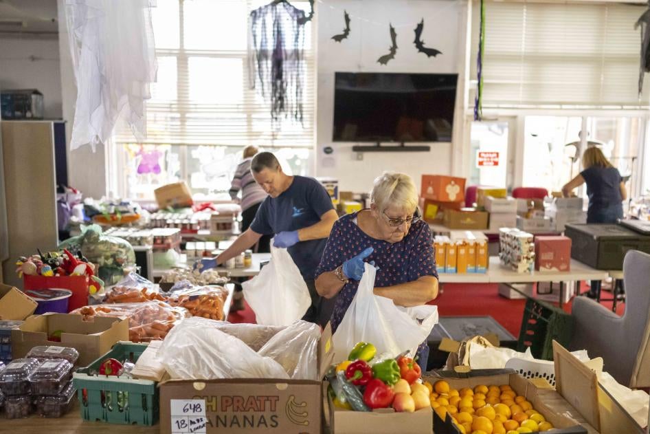 Volunteers sort food into food parcels at the Rumney Forum community charity on November 8, 2022 in Cardiff, Wales. 