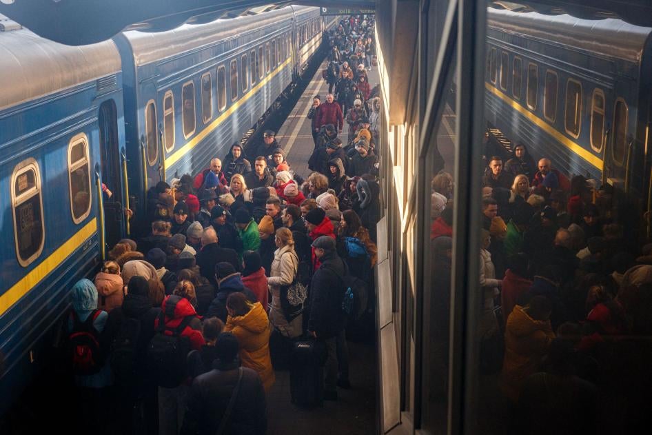 People board an evacuation train at Kyiv central train station.