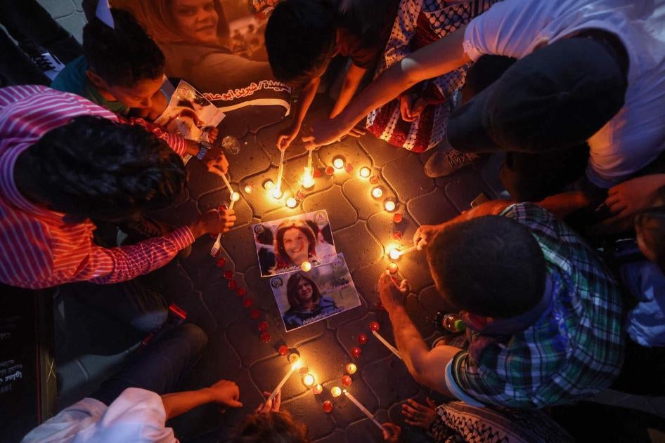 Gazans light candles during a vigil in honor of slain Palestinian American Al-Jazeera journalist Shireen Abu Akleh.