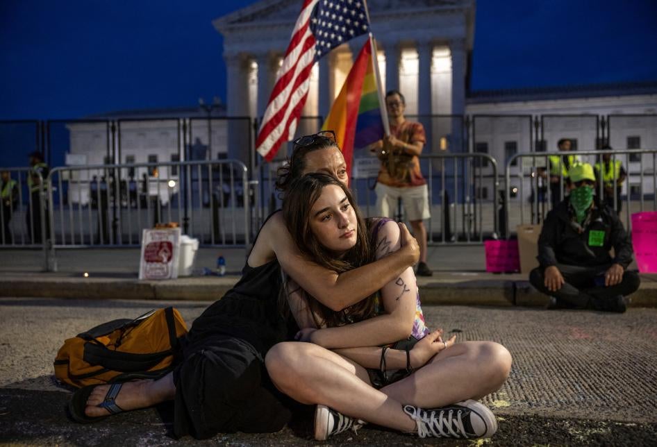 A woman holds her daughter during a candlelight vigil outside the United States Supreme Court in Washington DC