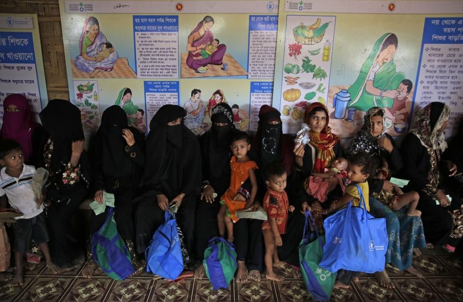 Rohingya refugees wait at a UN World Food Program facility to receive food supplements for their children in Kutupalong refugee camp.