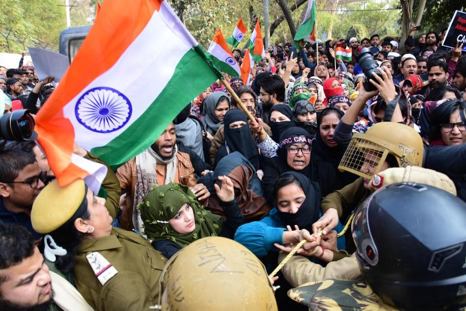 Police and demonstrators scuffle during a protest against discriminatory citizenship laws outside Jamia University in Delhi.