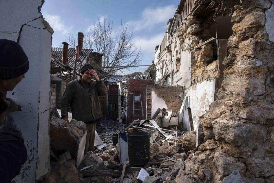 A man outside his bombed house