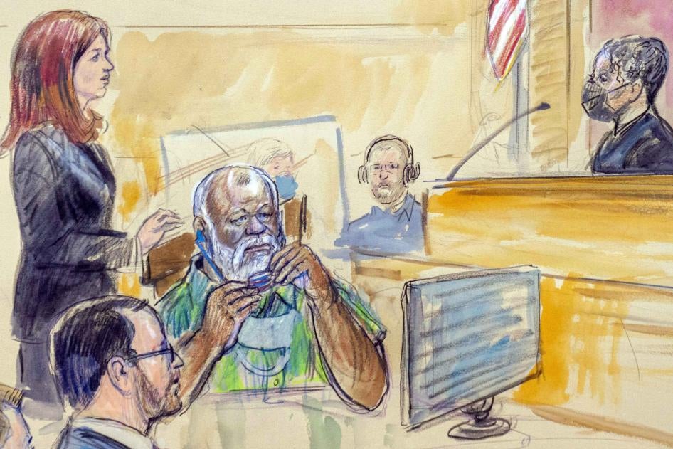 This artist sketch depicts Assistant US Attorney Erik Kenerson, seated from left, watching as Whitney Minter, a public defender from the eastern division of Virginia, stands to represent Abu Agila Mohammad Mas’ud Kheir Al-Marimi, center, accused of making the bomb that brought down Pan Am Flight 103 over Lockerbie, Scotland, in 1988, in federal court in Washington, DC, December 12, 2022. 