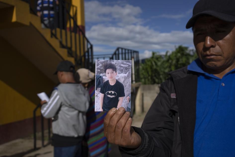 A man shows a portrait of Wilmer Tulul in Tzucubal, Guatemala. Wilmer and his cousin Pascual, both 13, were among the dead discovered inside a tractor-trailer near auto salvage yards on the edge of San Antonio, Texas.