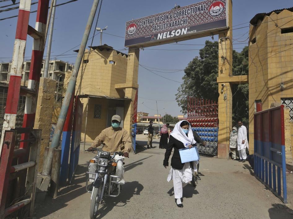 people exit the main entrance of the Karachi Central Prison