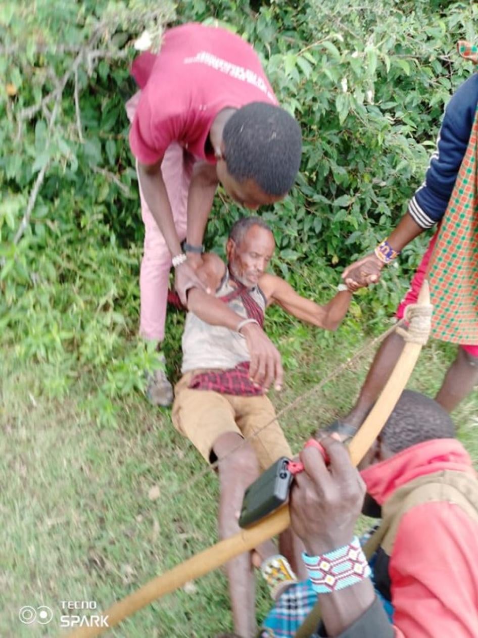 Tanzanian Maasai people helping an older Maasai man who had been beaten and injured by Tanzanian security forces after the outbreak of violence on June 10, 2022, in Loliondo, Arusha region, Tanzania. 