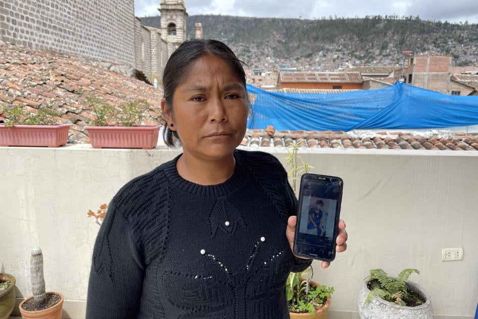 A woman shows a picture on her phone