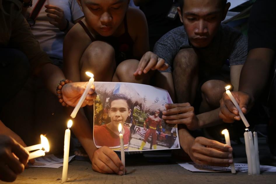 Activists light candles in front of the picture of 17-year-old student Kian delos Santos in Caloocan City, Philippines on November 29, 2018.