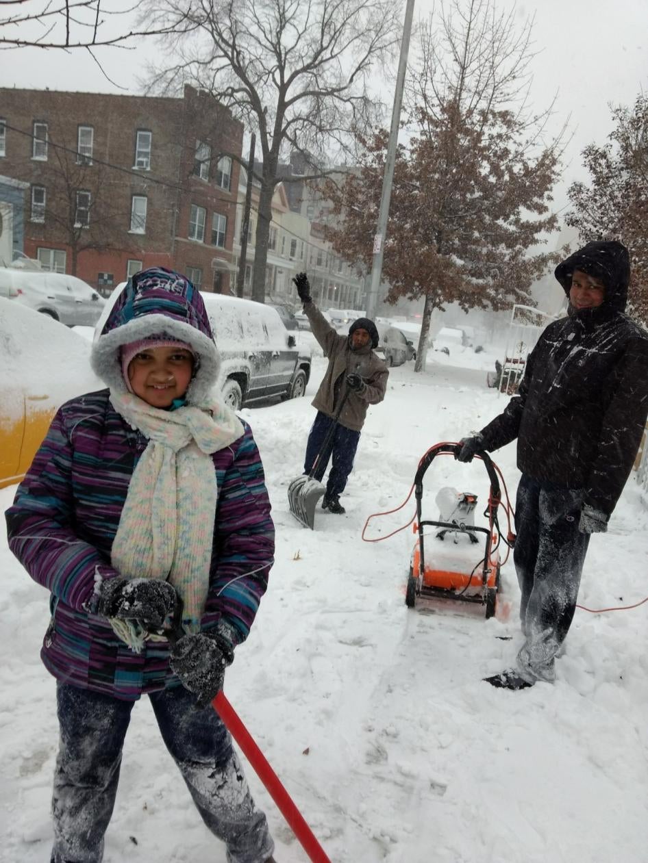 Subhajit Saha, right, and his father and sister shoveling snow at their home in New York in February 2021. Snow removal is a disability rights issue, particularly if city governments fail to adequately clear snow from sidewalks.
