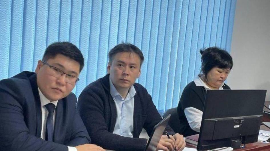 Zhanbolat Mamay, left/center, sits with his lawyers during a trial hearing in November 2022 in Almaty, Kazakhstan.
