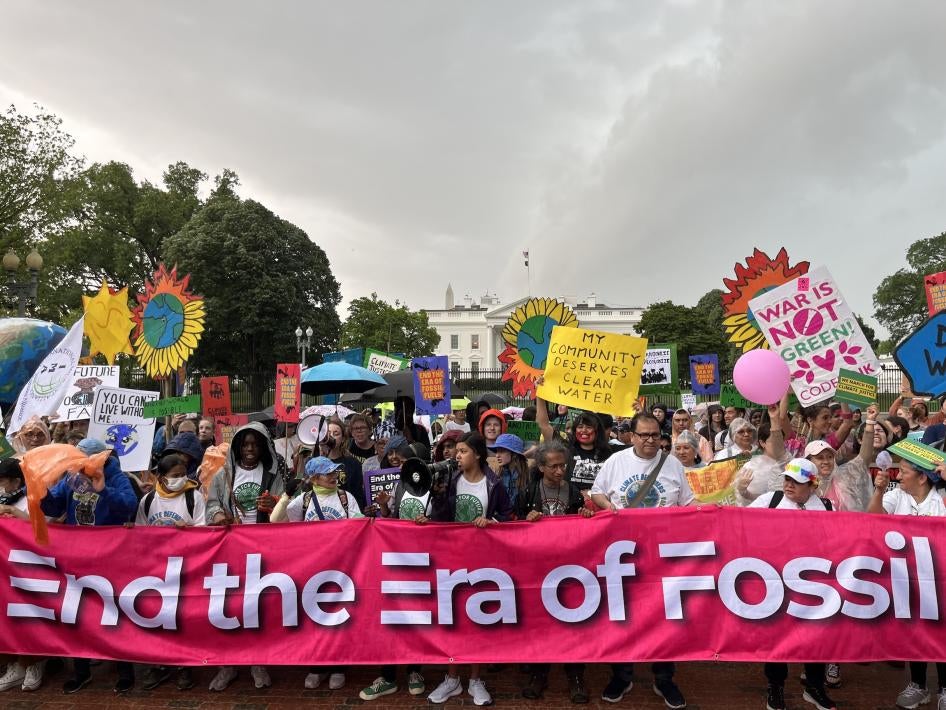 On Earth Day, marchers at the Whit House hold  a banner reading, “End the Era of Fossil Fuels” Washington, DC.