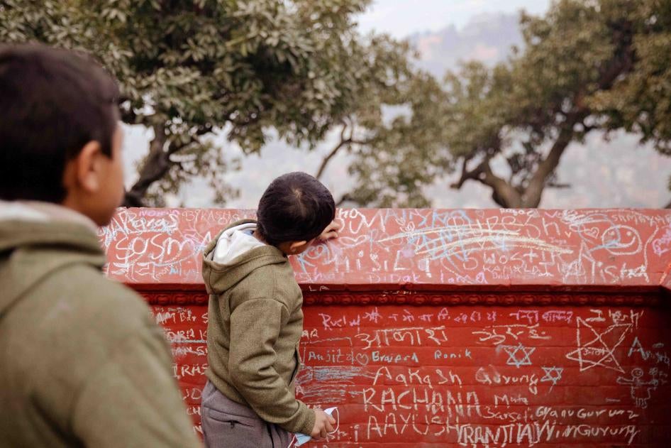 Children write in chalk on the walls of a Saraswati temple on the festival of Saraswati Puja