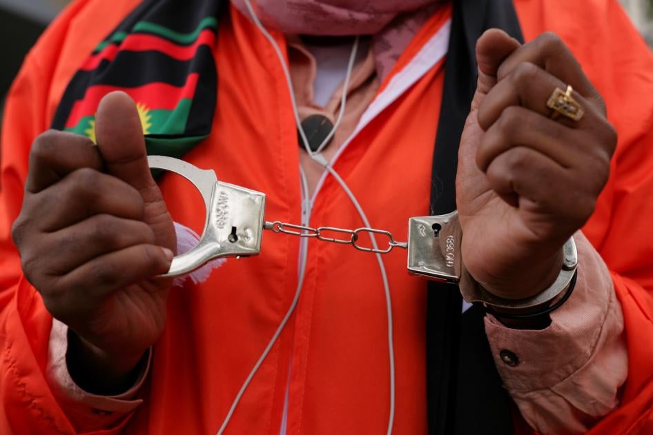 Activists in prison jumpsuits and handcuffs protest human rights abuses against the Oromo people in Ethiopia at a demonstration in London, October 10, 2020. © 2020 David Cliff/NurPhoto via AP